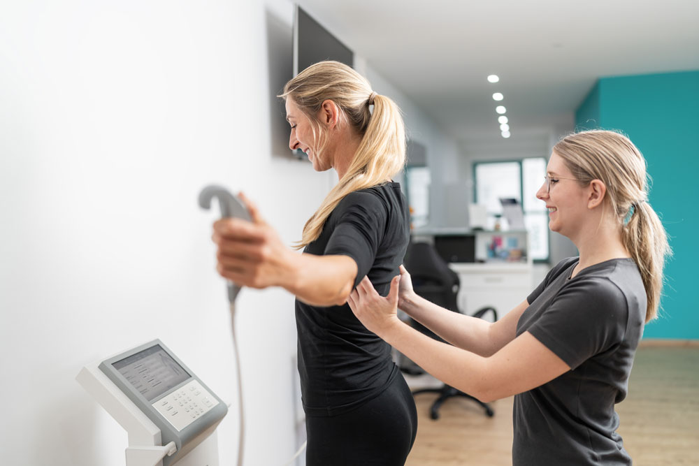 woman using a body composition measurement machine